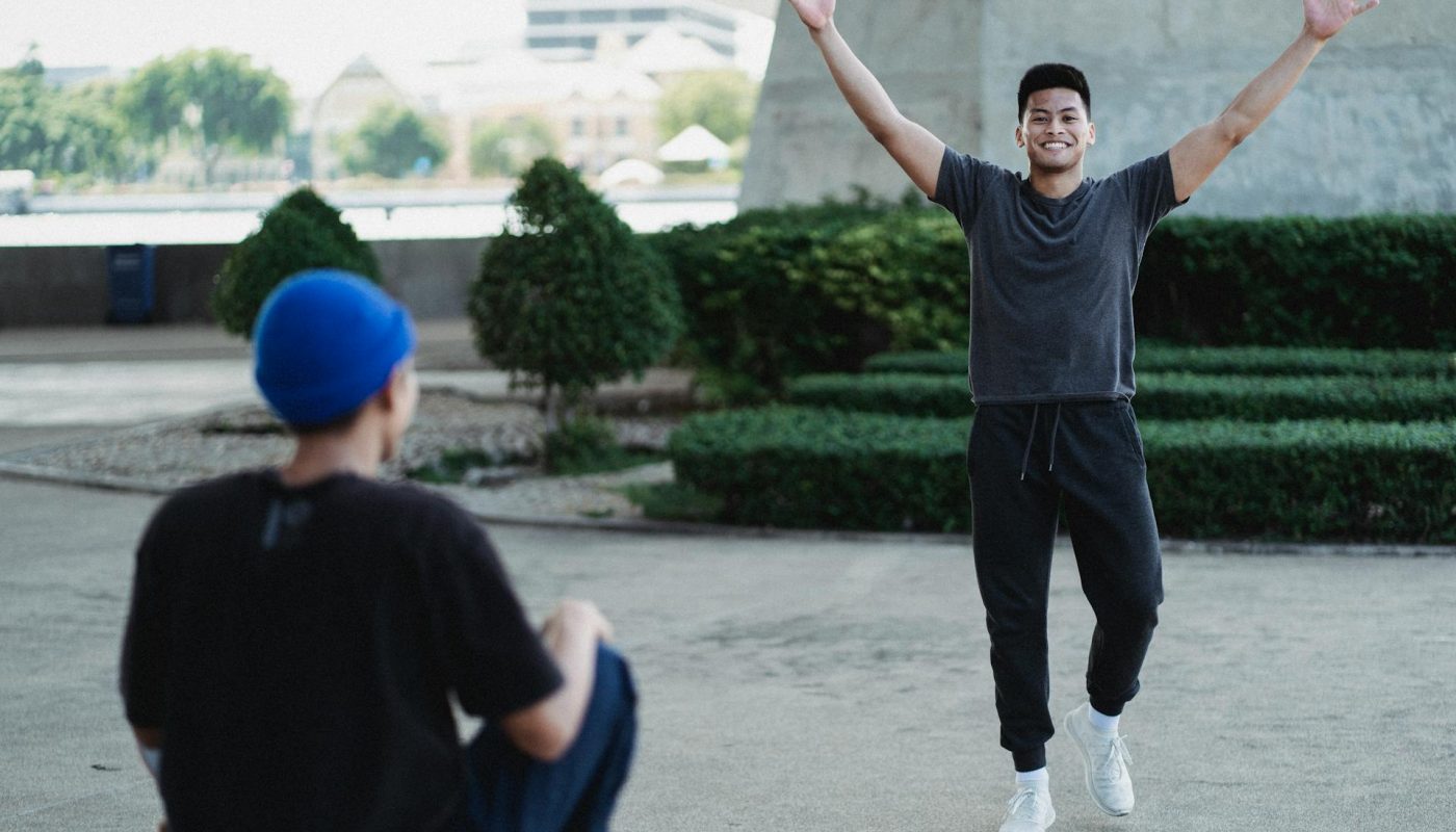 Photo by Allan Mas: https://www.pexels.com/photo/cheerful-asian-man-raising-arms-in-excitement-on-sunny-street-5368952/