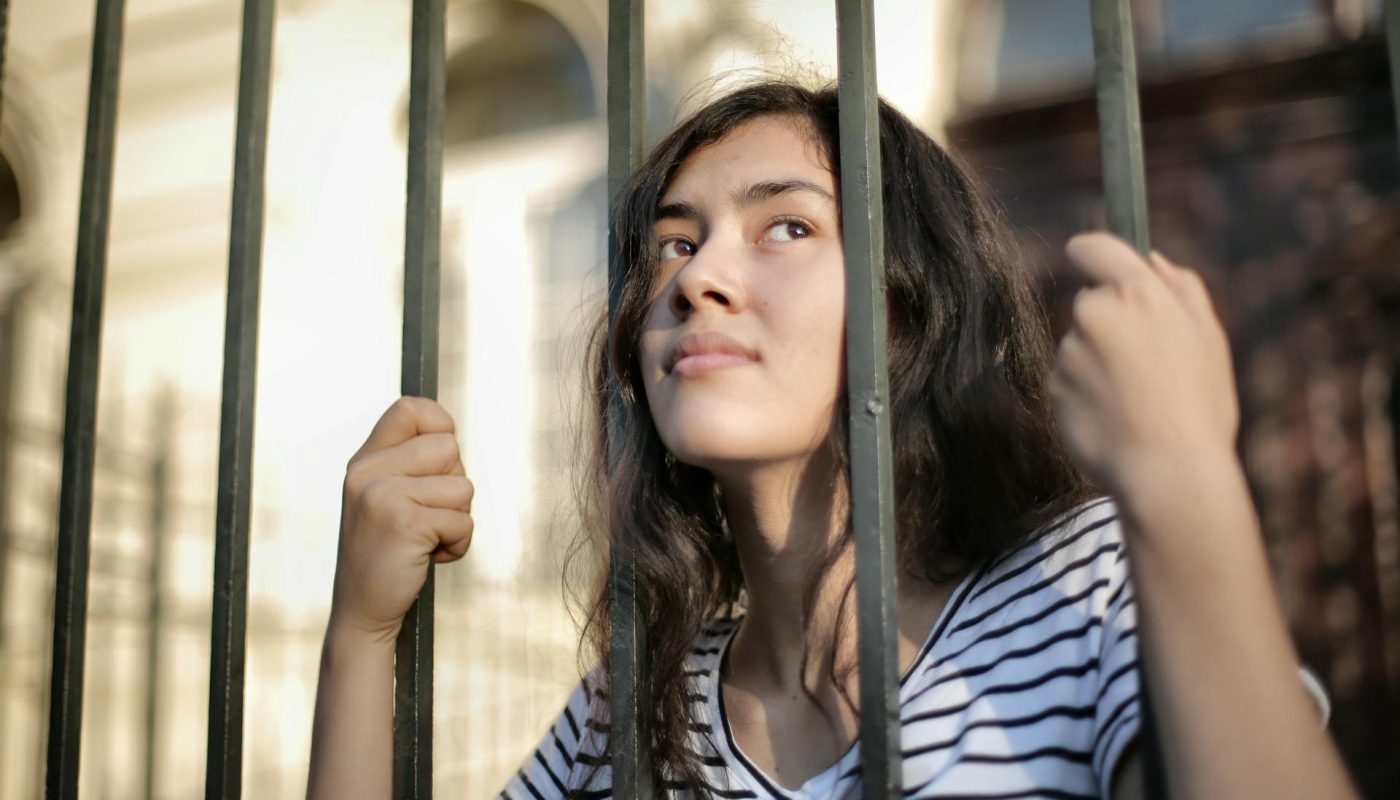 Photo by Andrea Piacquadio: https://www.pexels.com/photo/sad-isolated-young-woman-looking-away-through-fence-with-hope-3808803/